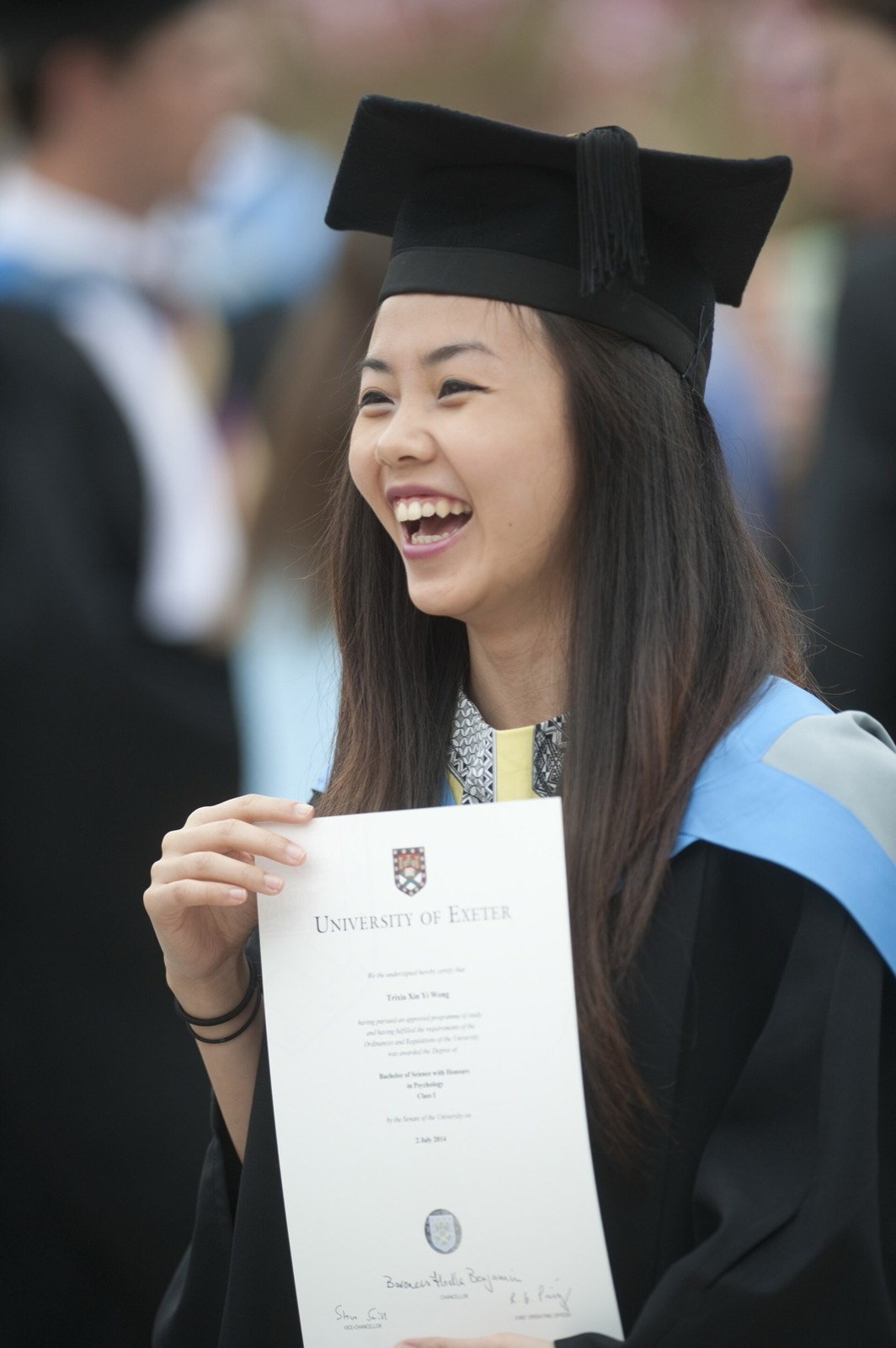 Graduate holding her diploma